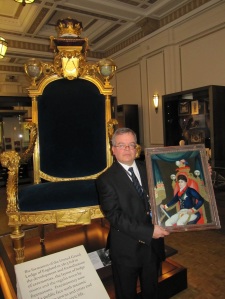Andrew Tucker with Chinese reverse glass painting in front of George, Prince of Wales' ceremonial chair in Three Centuries of English Freemasonry Gallery Courtesy of The Library & Museum of Freemasonry